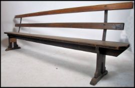 A stunning large early 20th century believed railway station bench. The bench with slatted seats and