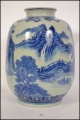 A Chinese blue and white kang-xi style vase with scenes of mountains and villages, the vase of