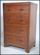 A 1930's Art Deco oak chest of drawers having reeded supports with an upright bank of drawers having