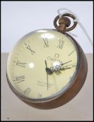 An unusual 20th century brass and glass fish eye ball clock with hoop bale atop