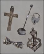 A collection of silver charms to include a Victorian Chester hallmarked anchor, heart and cross