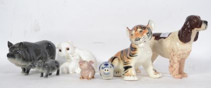 A collection of Beswick ceramic figurines to include grey pig sow and piglet, spaniel dog together