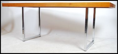 A large mid century 1960's Heals of London teak and chrome dining table. The table top of large
