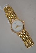 A Ladies Gucci gold plated wrist watch with articulated bracelet, mother of pearl dial inscribed
