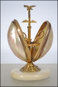 A 19th century continental mother of pearl and gilt metal sewing case, the alabaster circular base