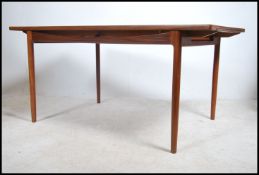 A superb Danish manner teak wood extending dining table by Kofod Larsen for G-Plan being raised on