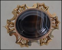 A heavy set 18ct gold large ladies agate set brooch. The thick 18ct gold surround with tigers eye