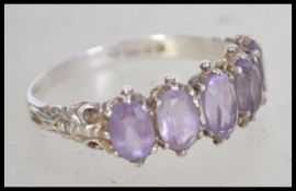 A 9ct white gold and hallmarked ladies amethyst set 5 stone ring being claw mounted on a gypsy
