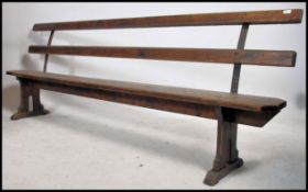 A stunning large early 20th century believed railway station bench. The bench with slatted seats and