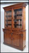 A Victorian mahogany library bookcase cabinet. Raised on plinth base with white ceramic castors