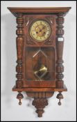 An early 20th century walnut cased Vienna wall clock in the manner of Gustav Becker, with turned