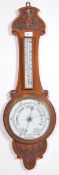 An early 20th century  banjo barometer /  thermometer, carved oak case, white scale and dial.