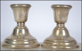 A pair of mid century silver hallmarked stub candlesticks  by FH Adams & Holman, Birmingham 1959.