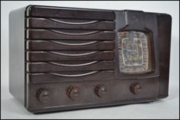 An vintage early to mid 20th century Bakelite valve radio by Westminster. Dials, knobs and speaker