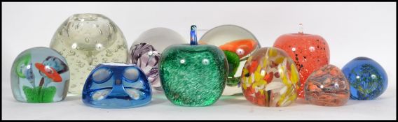 A collection of paperweights to include Liskeard Glass, Avondale fruits, Victorian Nailsea glass