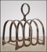 A silver hallmarked toast rack of small form with hoop handle centre. Marked for Cooper Bros & Sons,