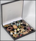 a collection of vintage and contemporary costume jewellery brooches and clip on earrings, to include