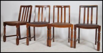 A set of 4 1940's oak dining chairs having railed backs over drop in seats and raised on block and