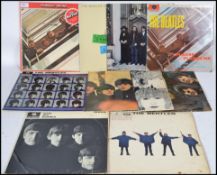 The Beatles - A collection of vinyl records all relating to The Beatles to include With The Beatles,