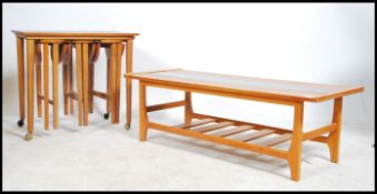 A retro 1970's teak and smoked glass rectangular coffee table with central glass panel over