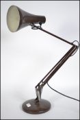 A 20th century retro Herbert Terry Anglepoise desk lamp having a circular base with conical shade in