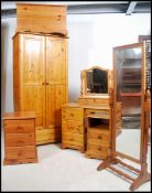 A collection of antique style country pine furniture to include wardrobe, bedside cabinets, dressing