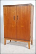 A 1970's rare believed G-Plan cocktail - drinks cabinet being raised on square tapered legs with