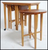 A vintage mid 20th century teak side - nest of tab
