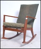A mid century Parker Knoll PK973-4 rocking chair - armchair having original upholsterery with shaped