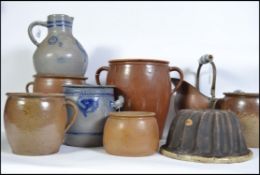 An interesting group of eight German ceramic pots/jugs/vases of various sizes three of which are