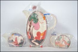 Wedgwood Clarice Cliff Bonjour coffee set comprising a coffee pot, creamer and sugar bowl.  This