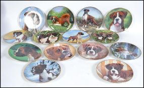 A collection of fourteen  collectors plates from Danbury Mint depicting Boxer dogs.