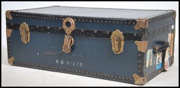 A mid century vintage large blue steamer trunk chest having clasp handles with blue panel body