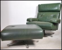 A 1970's large retro green leather upholstered swivel chair - armchair in the manner of Tetrad.
