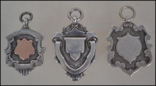 3 silver hallmarked armorial fobs, each with plain cartouche centres. Hallmarked for Birmignham,