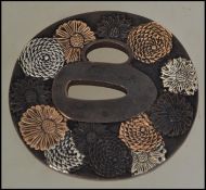 A Chinese / Japanese asiatic bronze Tsuba having uinusual flower head design bearing signature to