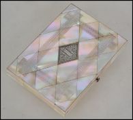 A Victorian mother of pearl shell card case, the mother of pearl with wriggle-work engraving, set