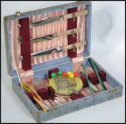 A vintage mid 20th century cased cocktail accessories kit to include knives, swizzle sticks,