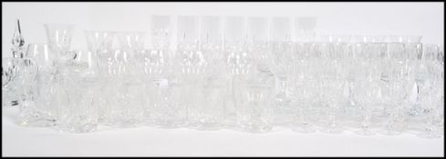 An extensive collection of lead cut crystal glasses to include wine glasses, port glasses, champagne