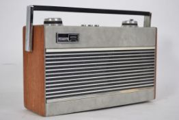 A vintage 1970's Roberts portable Radio .Model No R25 having teak and grey vinyl case. Battery and