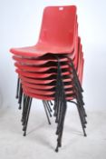A set of 8 plastic stacking chairs by Robin Day. The cast seat frames with angular legs and elbow