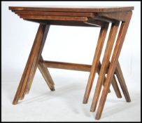 A good 1960s retro Danish teak wood nest of tables having angular legs united by central