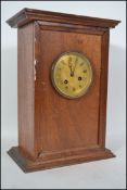 A late 19th / early 20th century mahogany cased mantle clock with a chased brass dial, Roman numeral