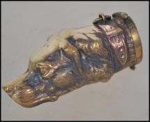 A 20th century brass cased vesta in the form of a hunting dog having hinged cap end and bale.