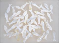 A collection of 50 Oriental 19th century mother of pearl gaming counters / gambling chips in the