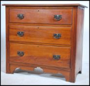 An Edwardian walnut cottage chest of drawers having a straight run of drawers with reeded fronts and