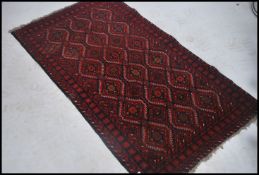A good sized 20th century Persian carpet rug on red ground having a continual geometric border and