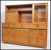 A vintage 1970's Nathan Furniture teak sideboard having quarter panel cupboards over short drawers