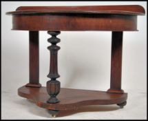 A Victorian mahogany demi-lune console hall table being raised on shaped supports with lower tier