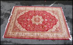 A large North Western Iranian / Persian Heriz carpet - rug having red and beige ground with